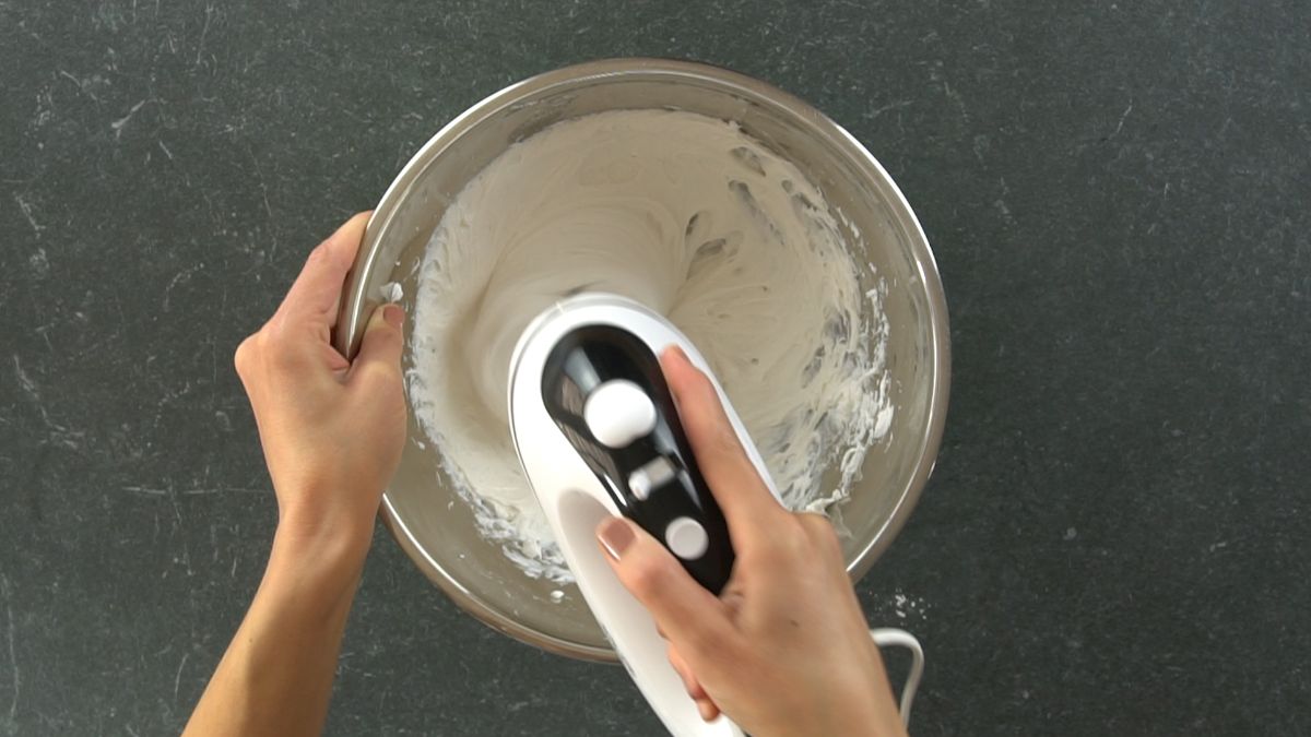 hand mixer in bowl with cream cheese