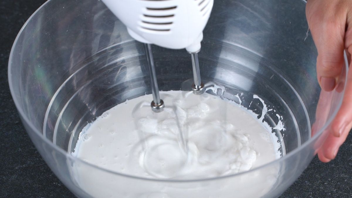 mixer in glass bowl with whipping cream