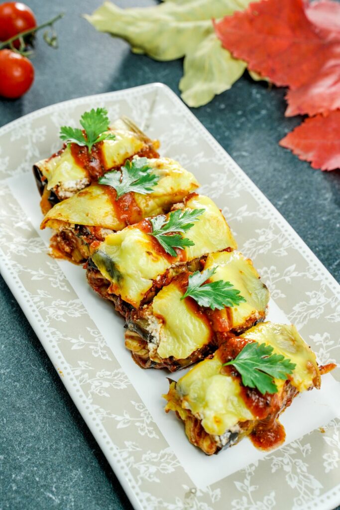 white platter of eggplant rollups topped with parsley