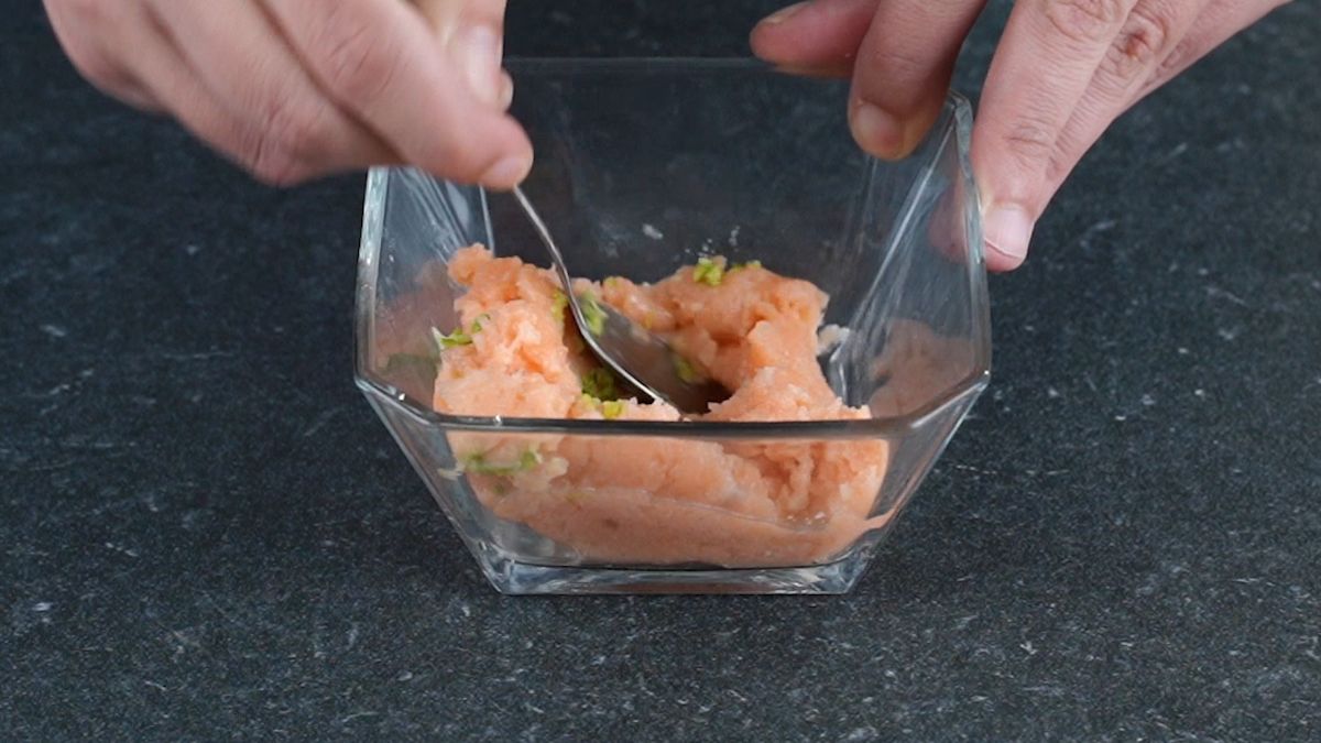 glass bowl of salmon being mixed