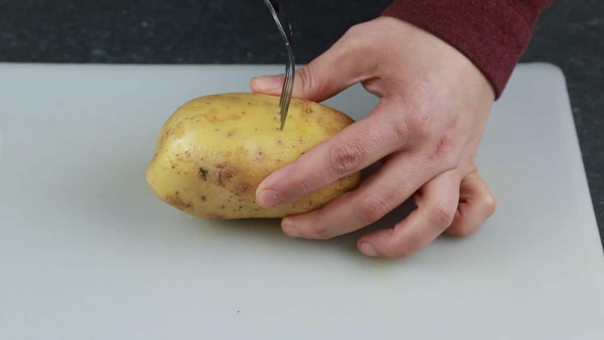 fork poking holes into potato