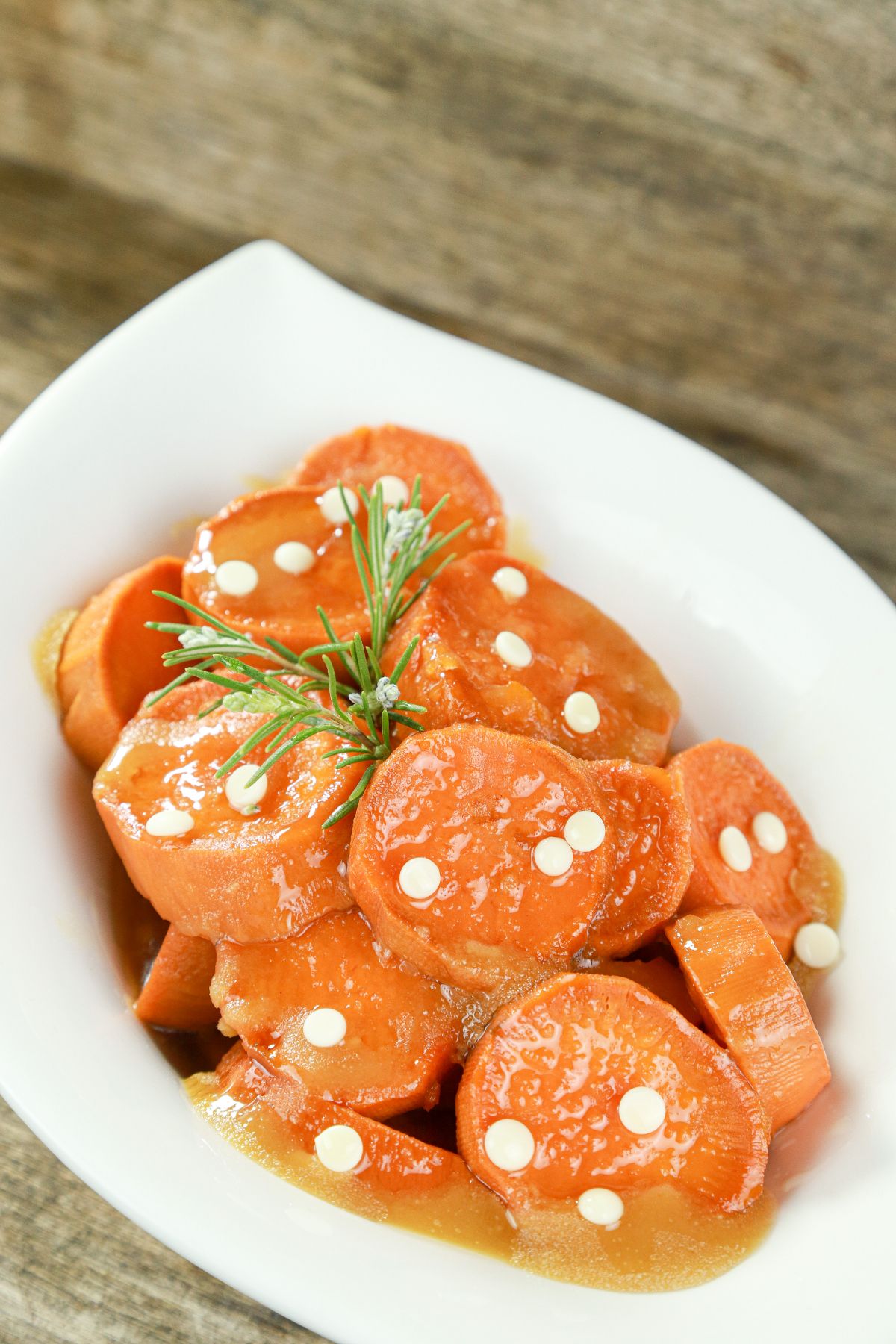 closeup of candied sweet potatoes in white bowl