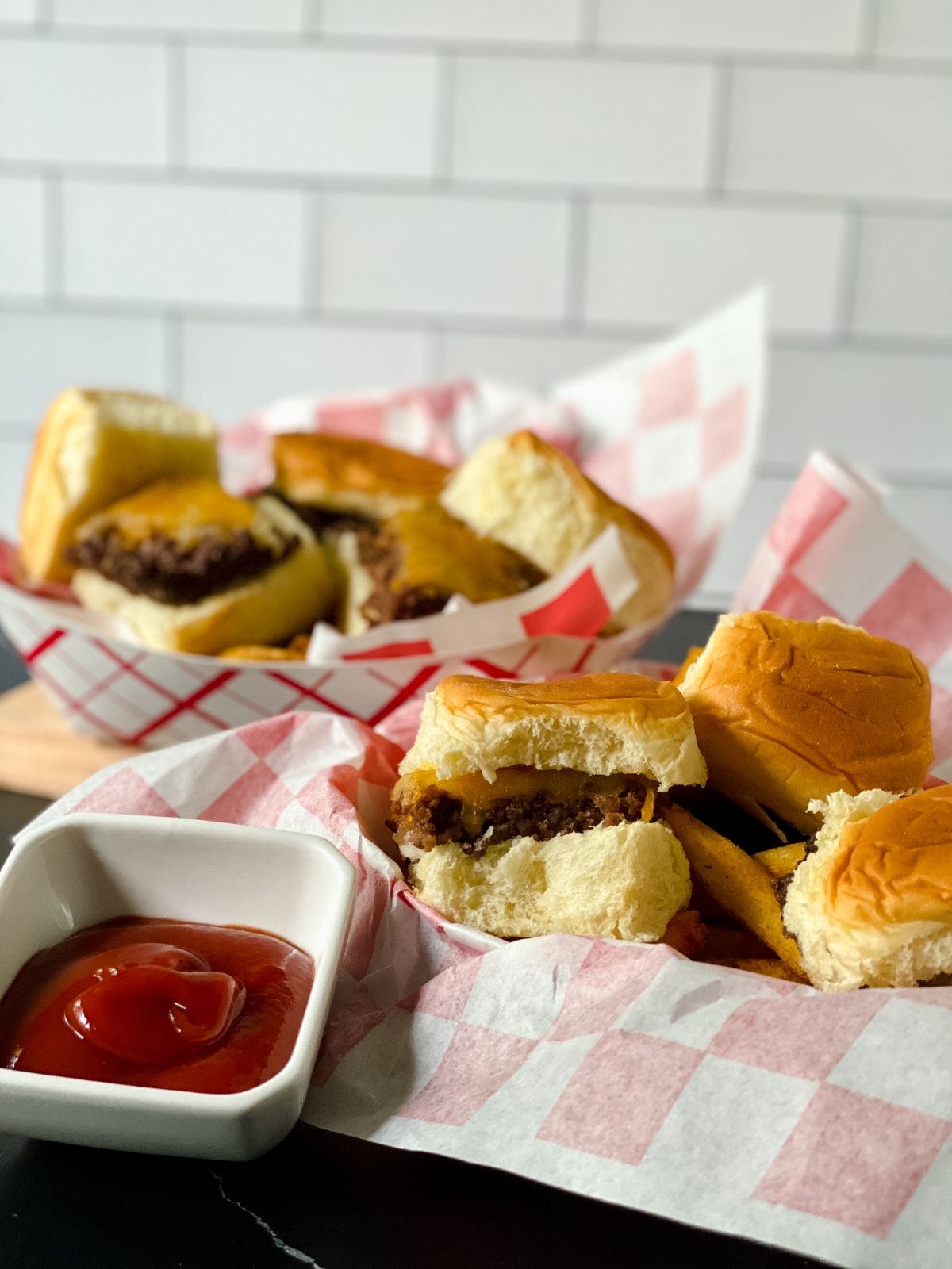 cheeseburger sliders in basket with checkered paper