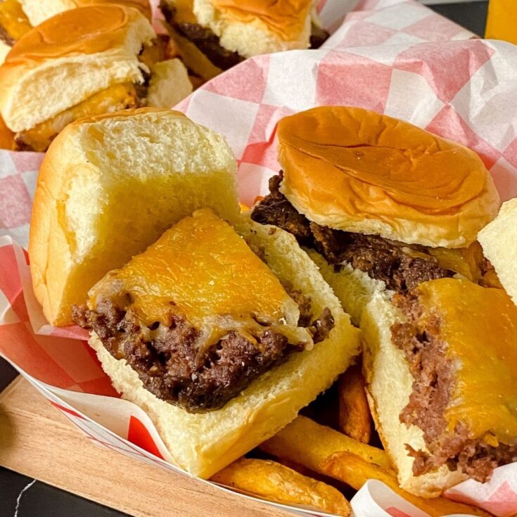 cheeseburger sliders in basket with checkered paper