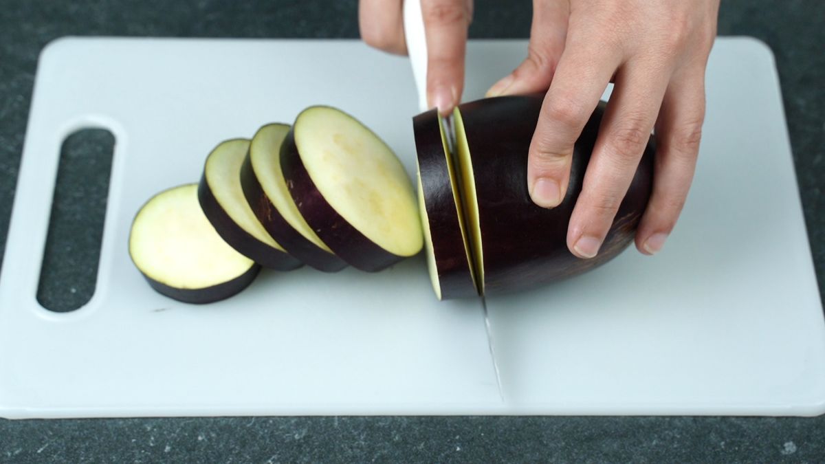 eggplant slices on white cutting board