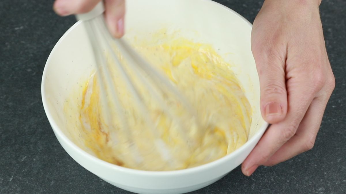 whisk in cream bowl of eggs