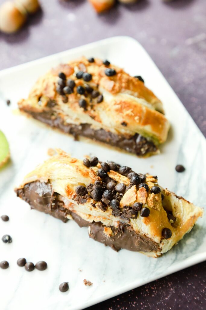 chocolate chips on top of chocolate dessert bread on white plate