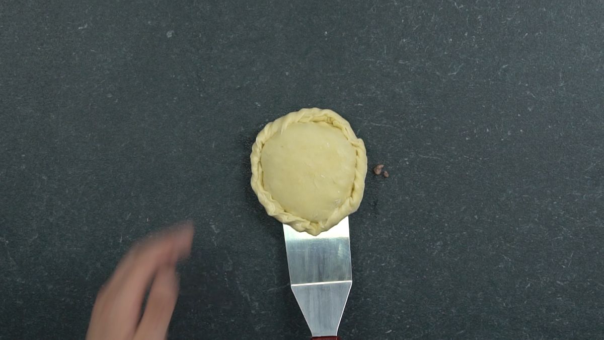 fork crimping edges of dough round