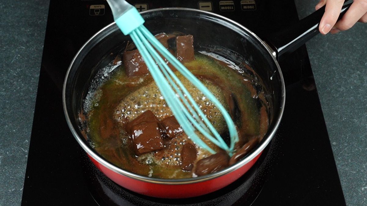 chocolate and butter in pan with teal whisk