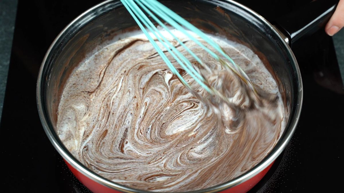 whisking flour into chocolate