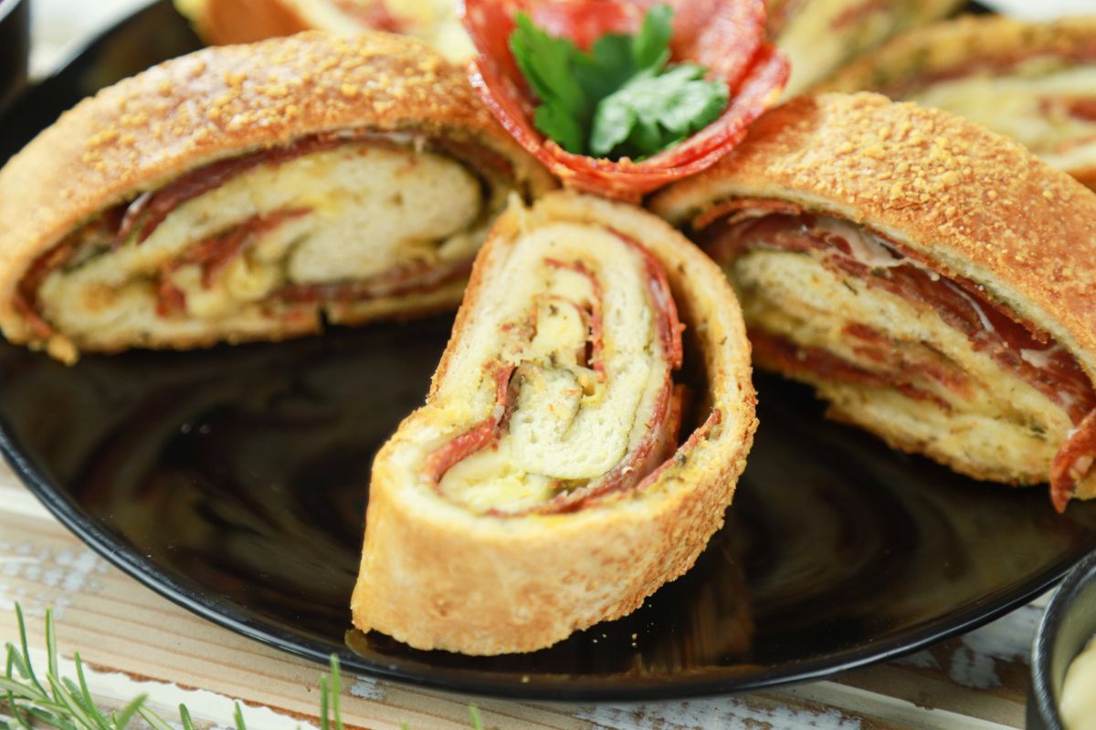 sliced stromboli filled with meat and cheese