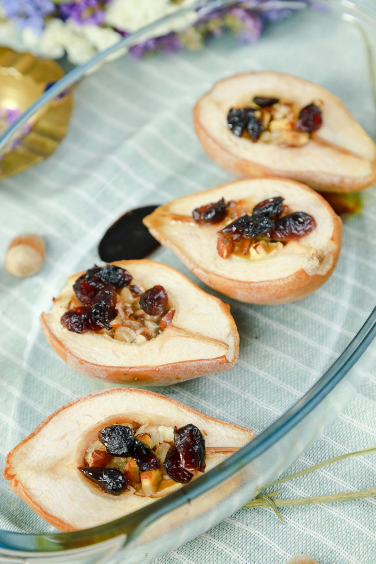 four berry and cheese stuffed baked pears on glass platter