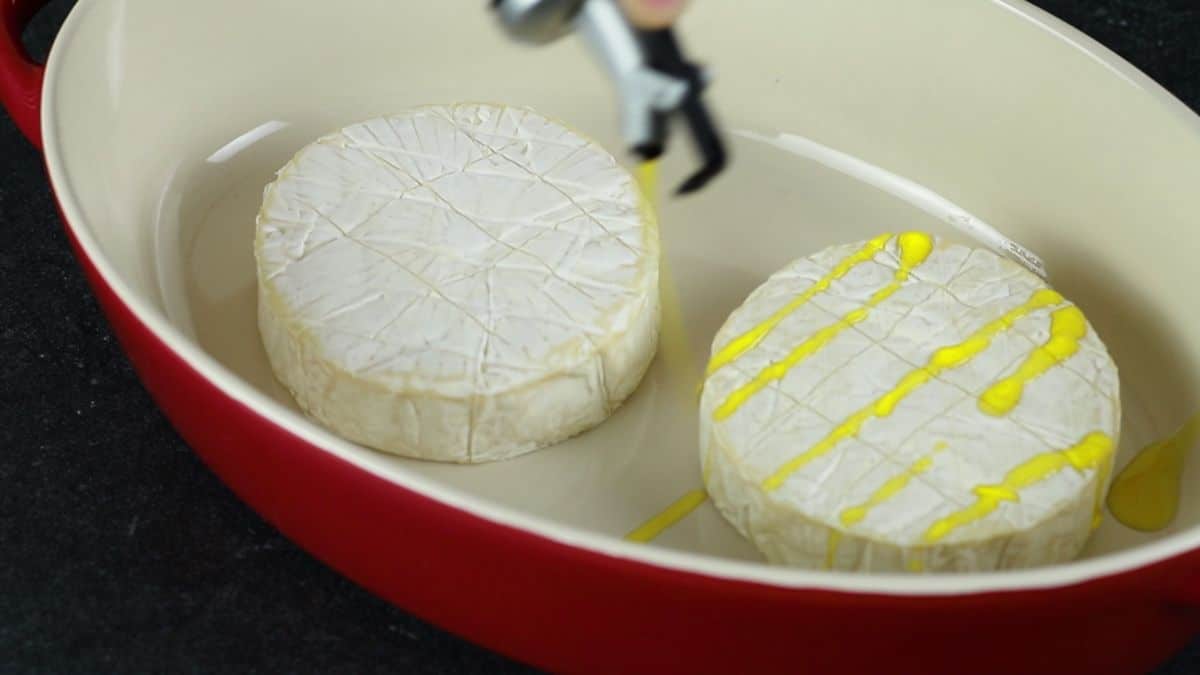 olive oil on top of brie in red dish