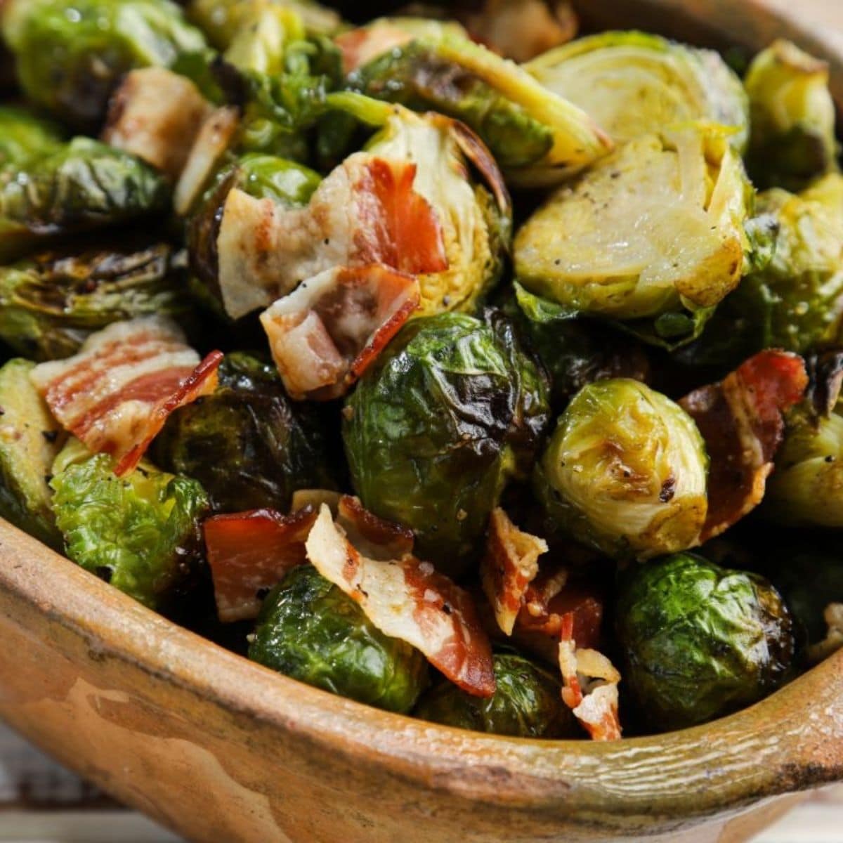 brown bowl of brussels sprouts with bacon