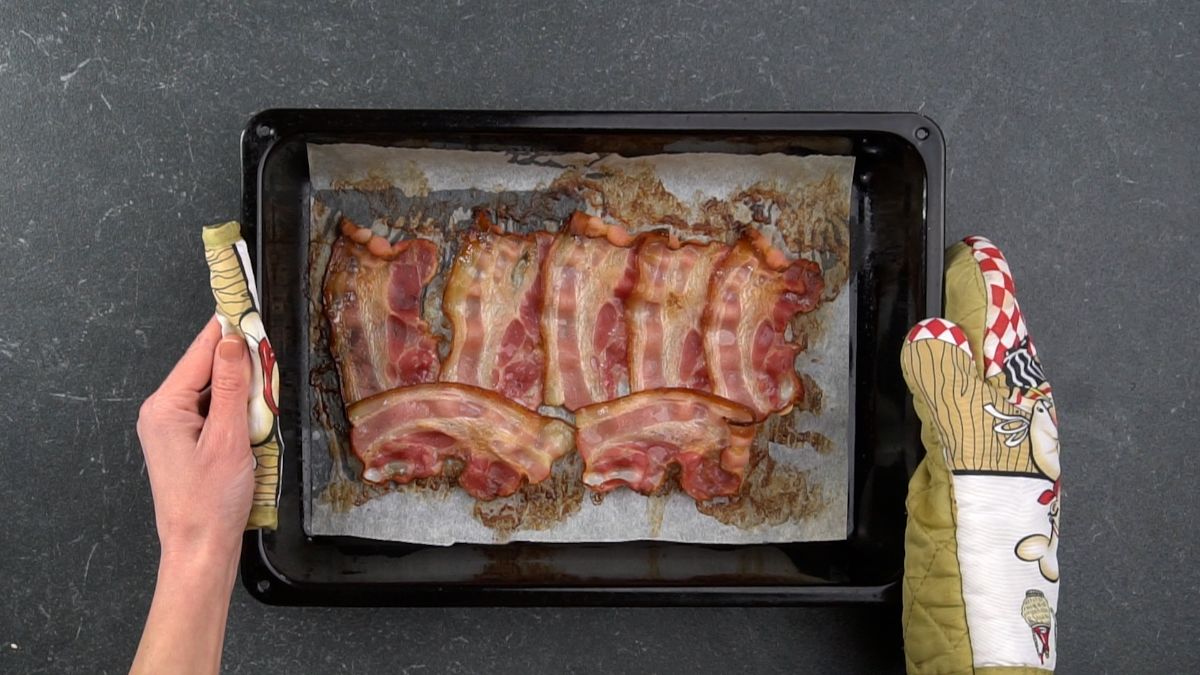 cooked bacon in baking sheet