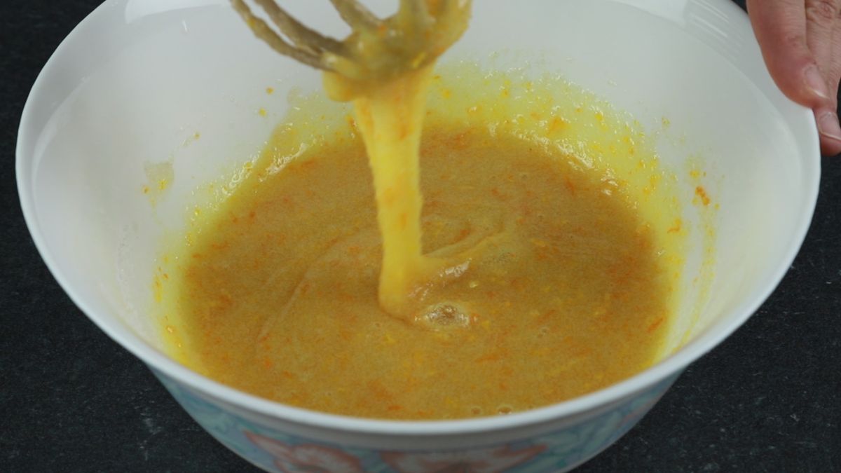 whisk in white bowl with egg and sugar