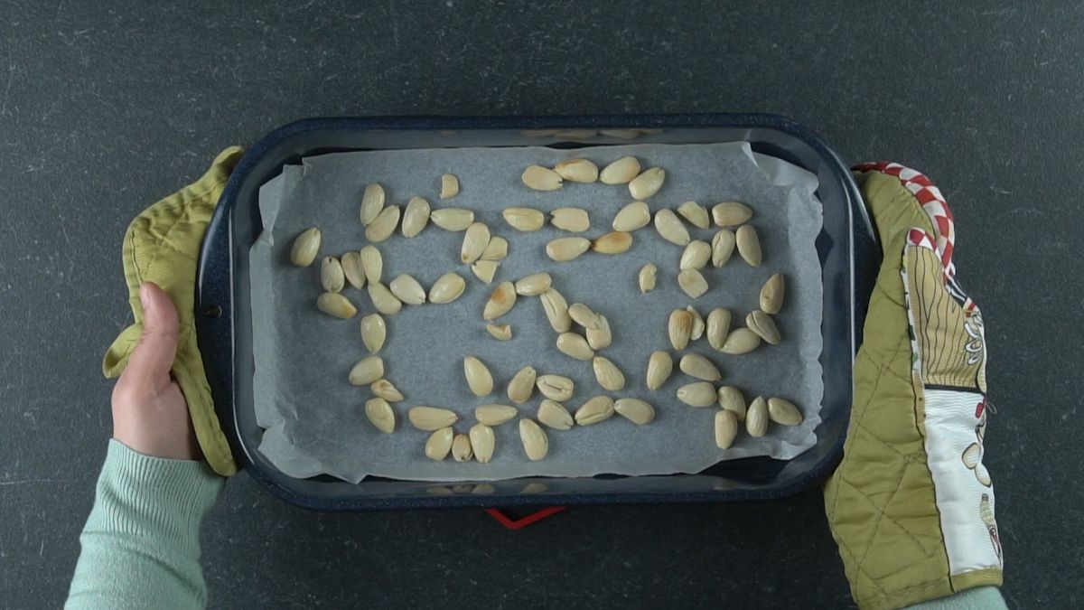 toasted almonds on parchment lined baking sheet