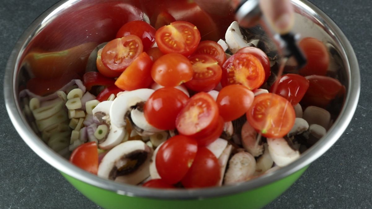 tomato and mushroom on top of bowl of vegetables