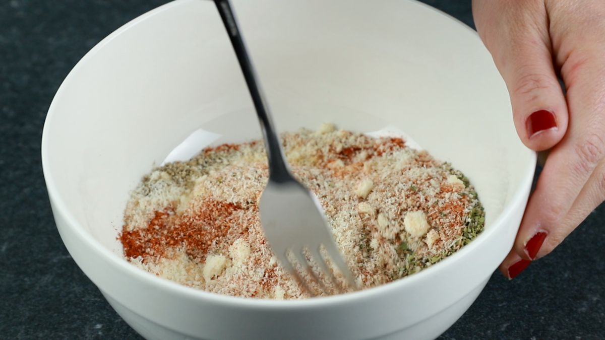 white bowl of cheese and spice with fork