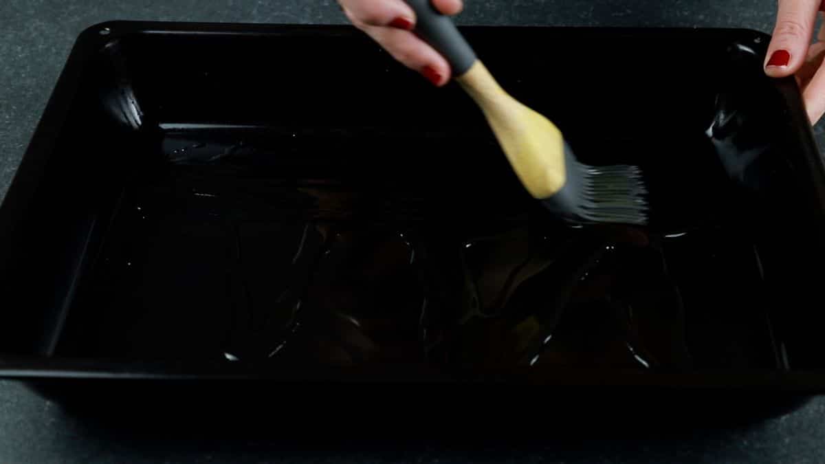 pastry brush of oil in black pan