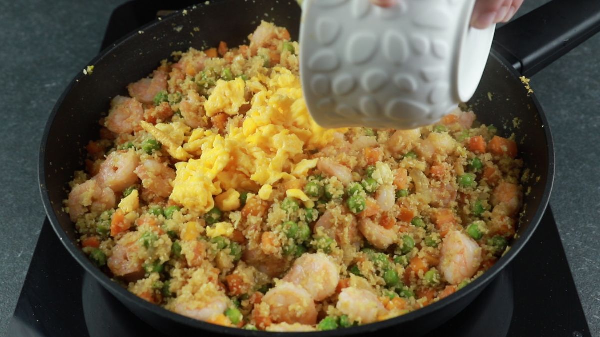 eggs being added to cauliflower fried rice