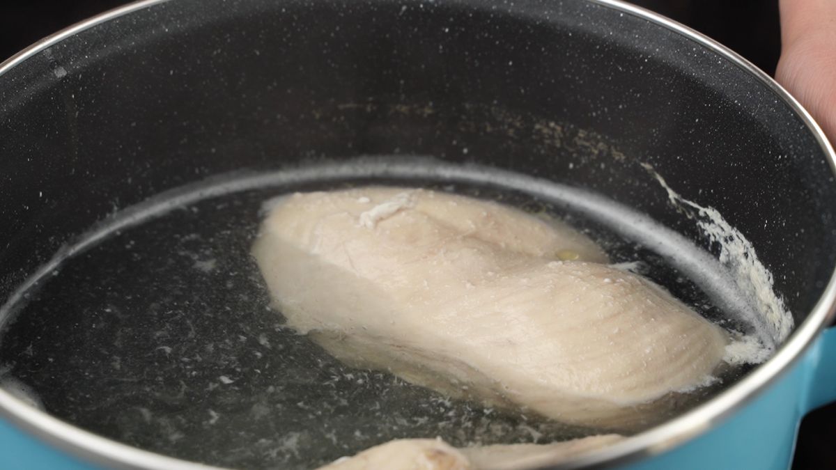 chicken breasts in pot with water