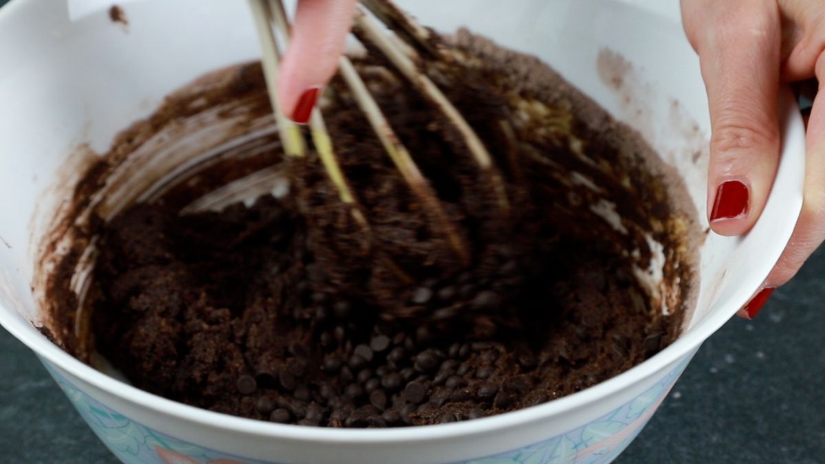 whisk in white bowl of chocolate batter