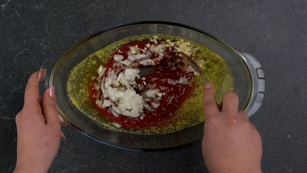 spices being added to bowl of sauce
