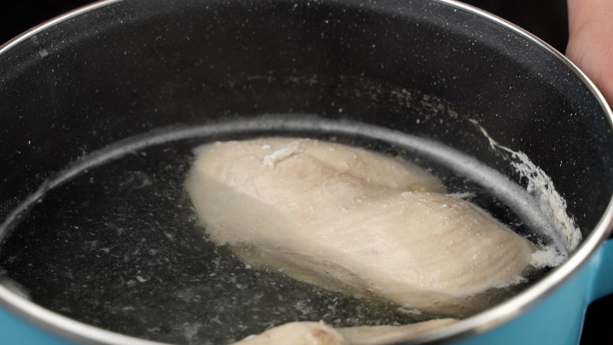 chicken in stockpot of water