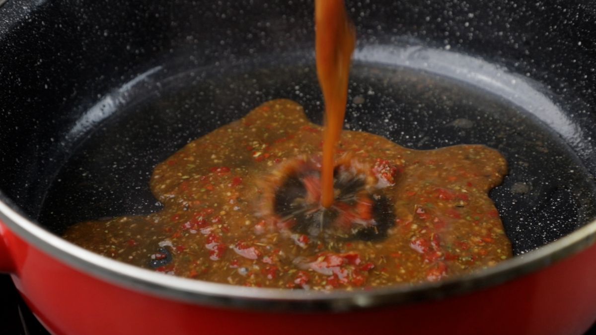 sauce being poured into skillet