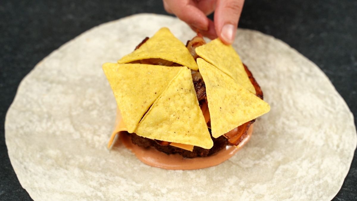 chips on top of burger on tortilla