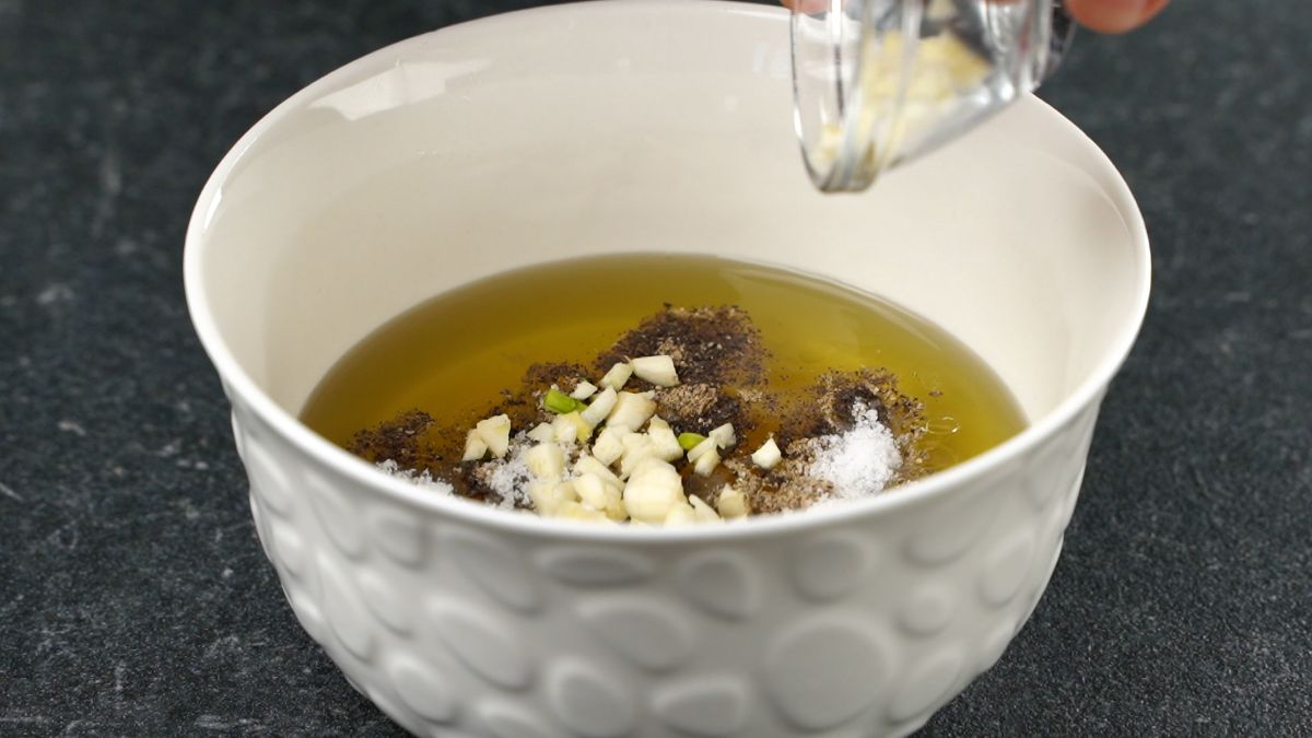 vinaigrette in white bowl being mixed