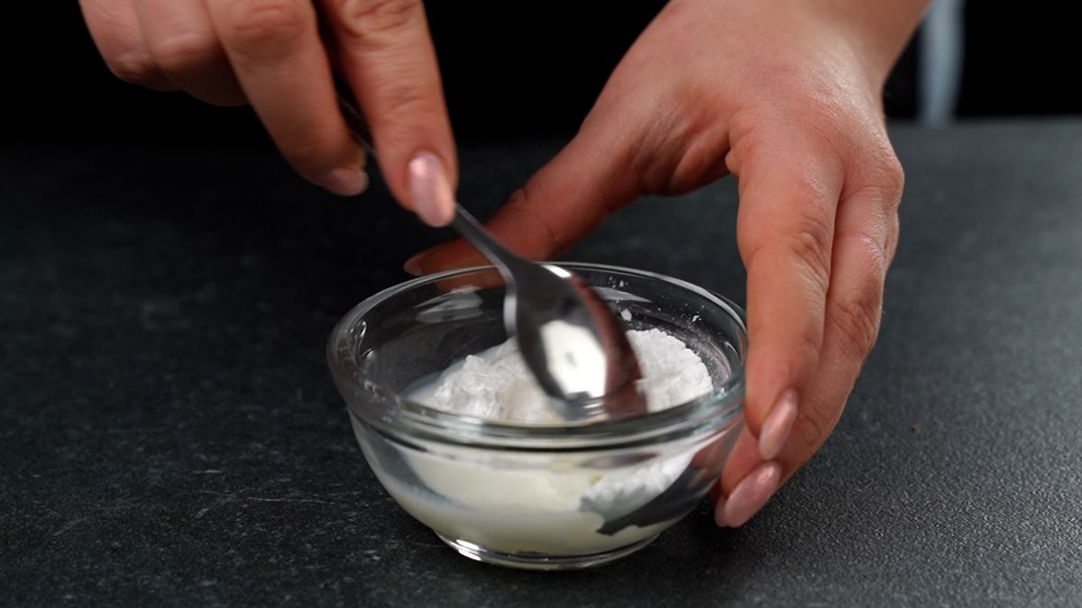 hand stirring glaze in small bowl