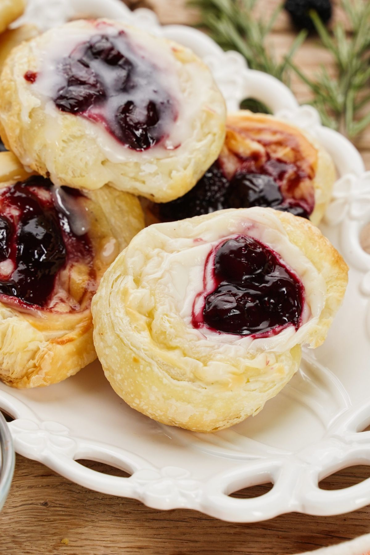 white oval plate filled with cherry danishes