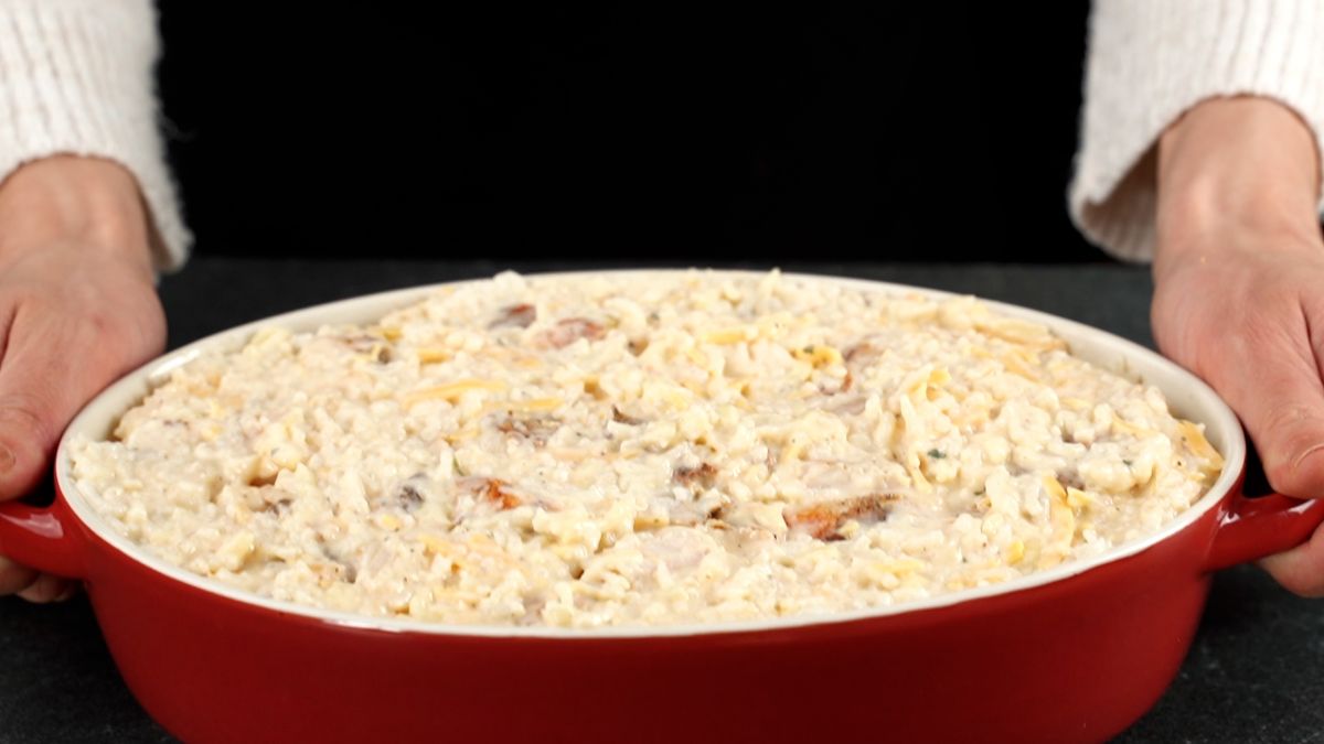 oval red baking dish of chicken and rice