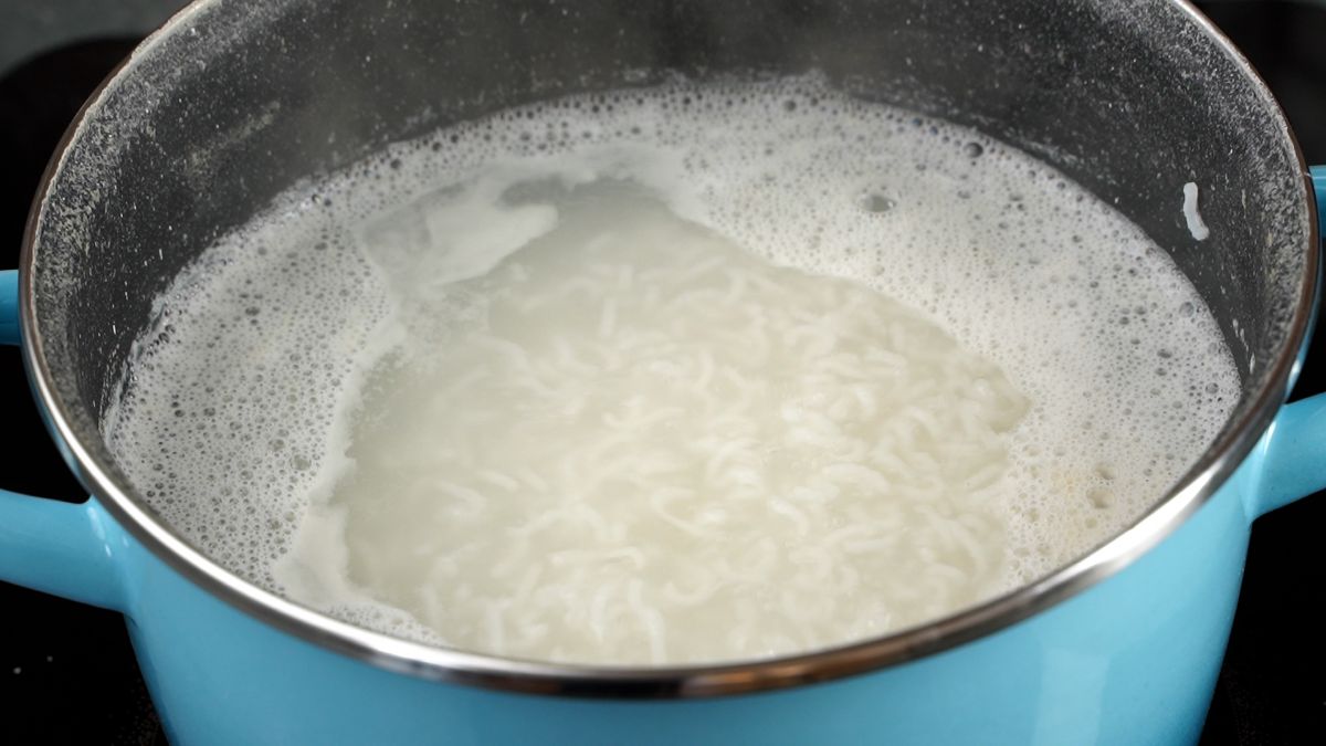teal saucepan of rice and water