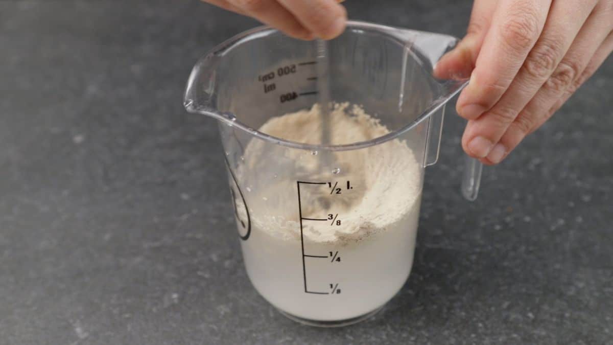 water and yeast in measuring cup