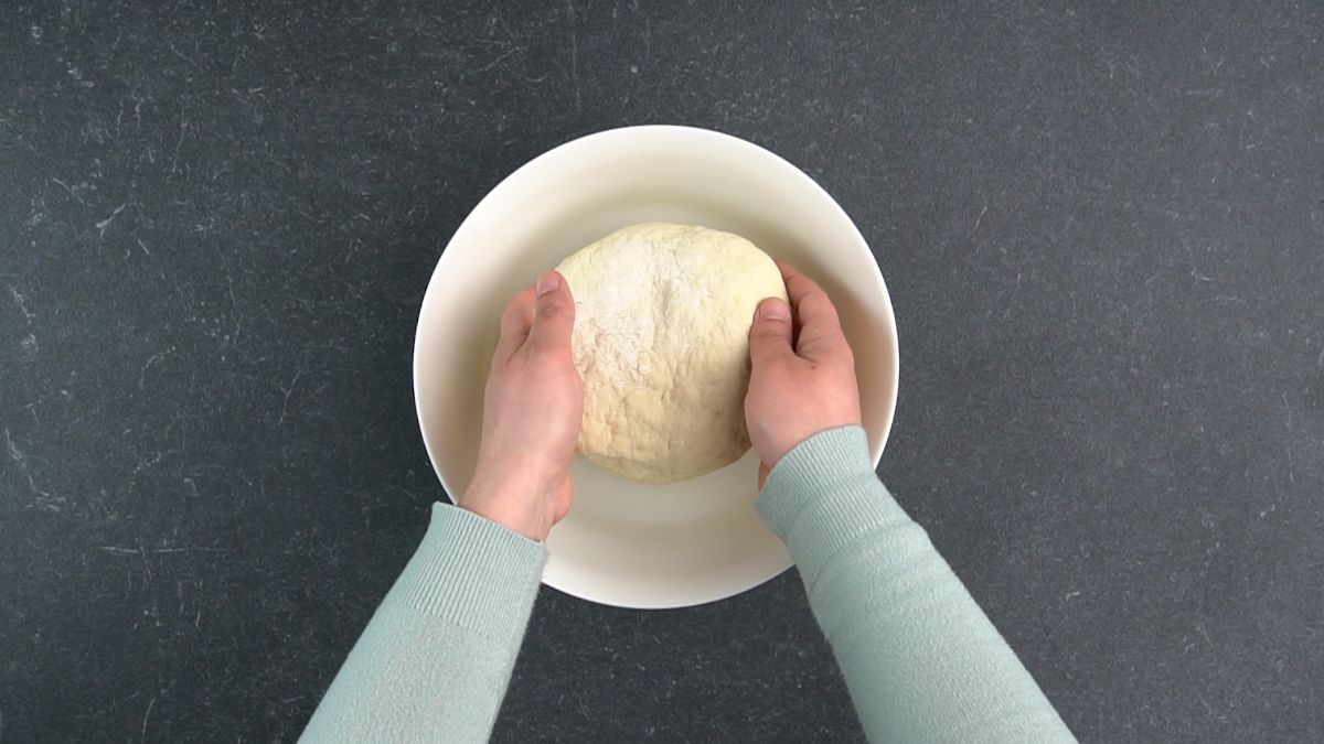 dough being put into white bowl