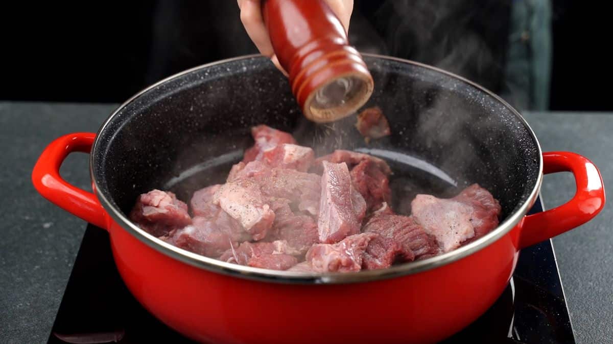 seasoning beef in skillet