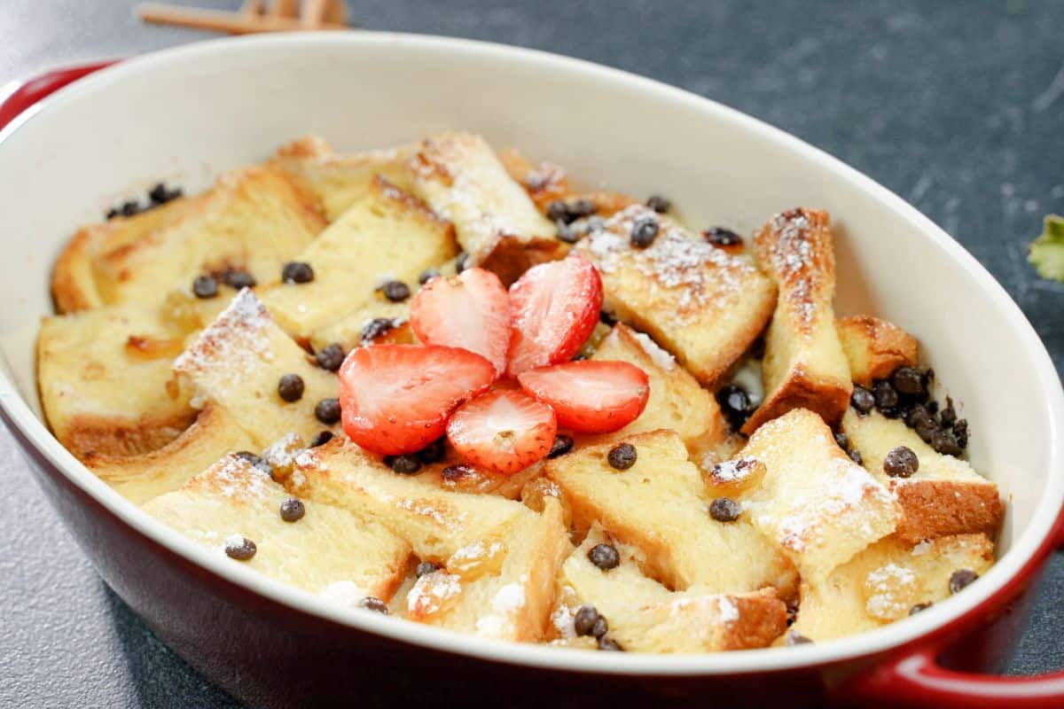 oval casserole dish of bread pudding with strawberries