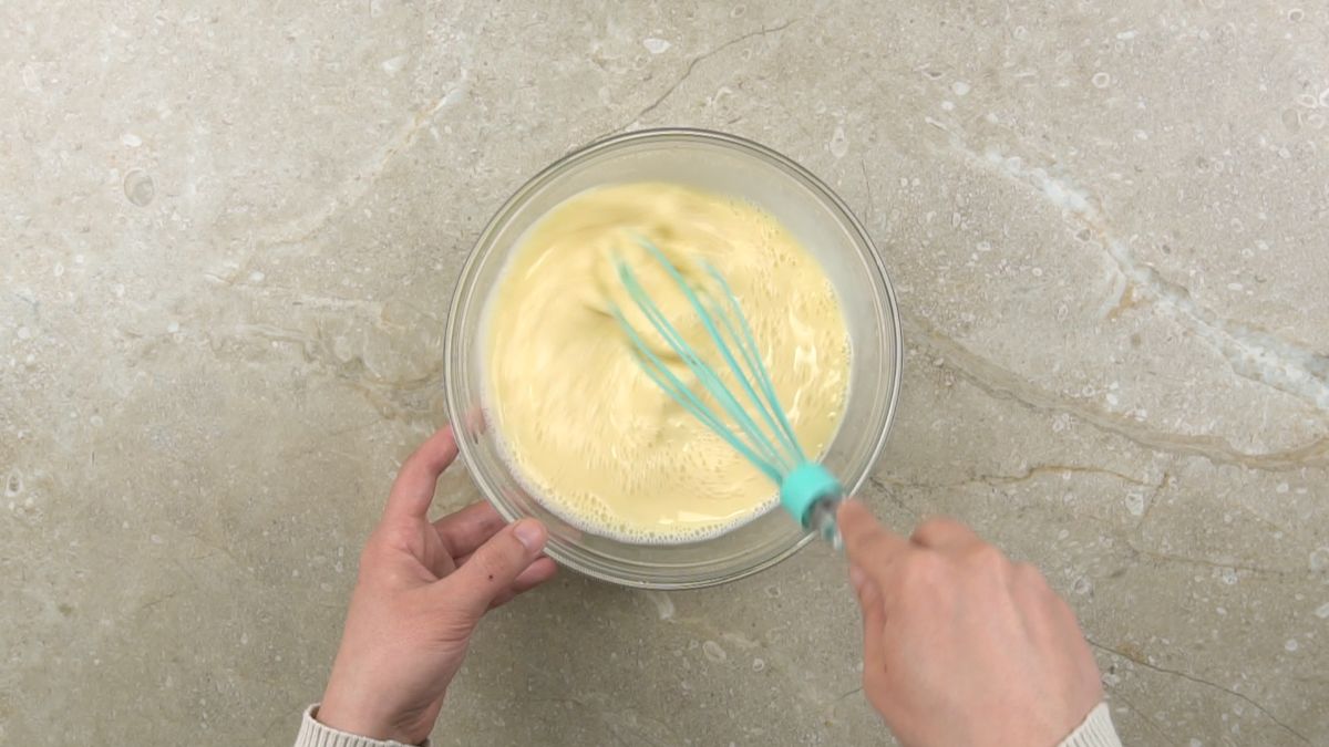 custard being whisked by teal whisk