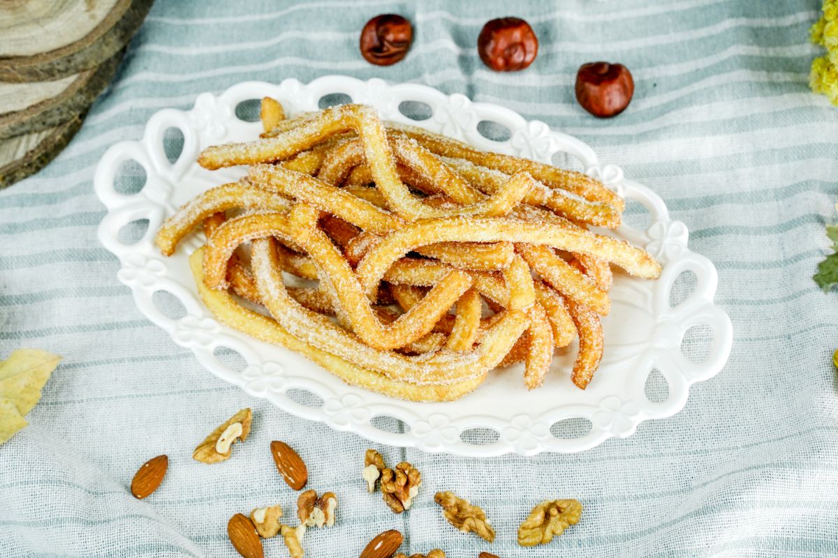 white oval plate holding churros