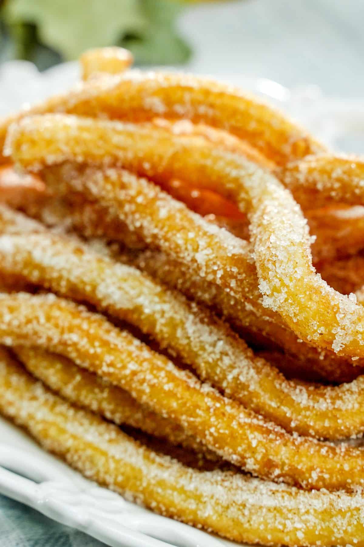 stack of churros on white plate