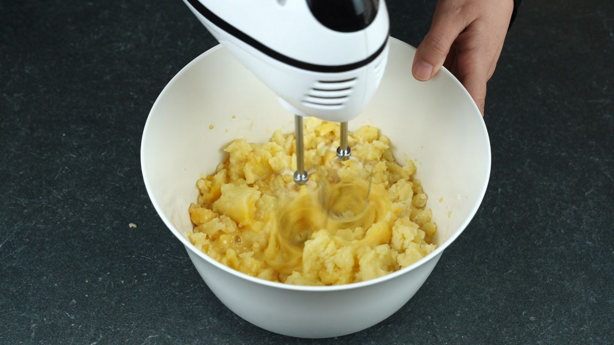 hand mixer beating dough in white bowl