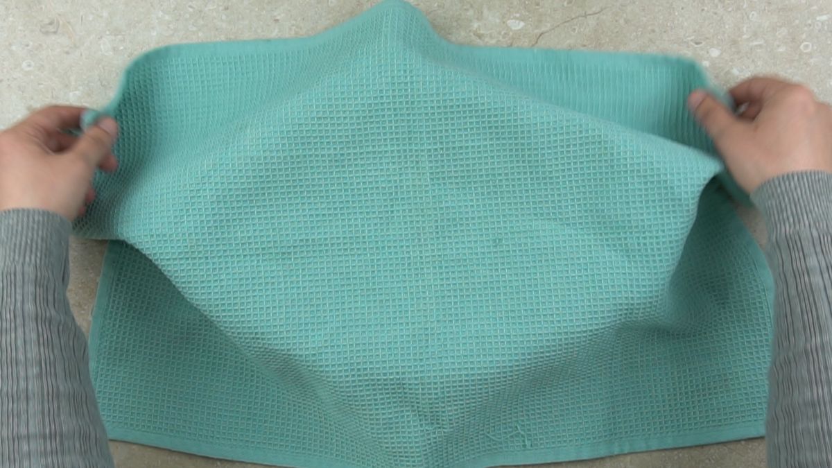 baking dish covered with teal tea towel