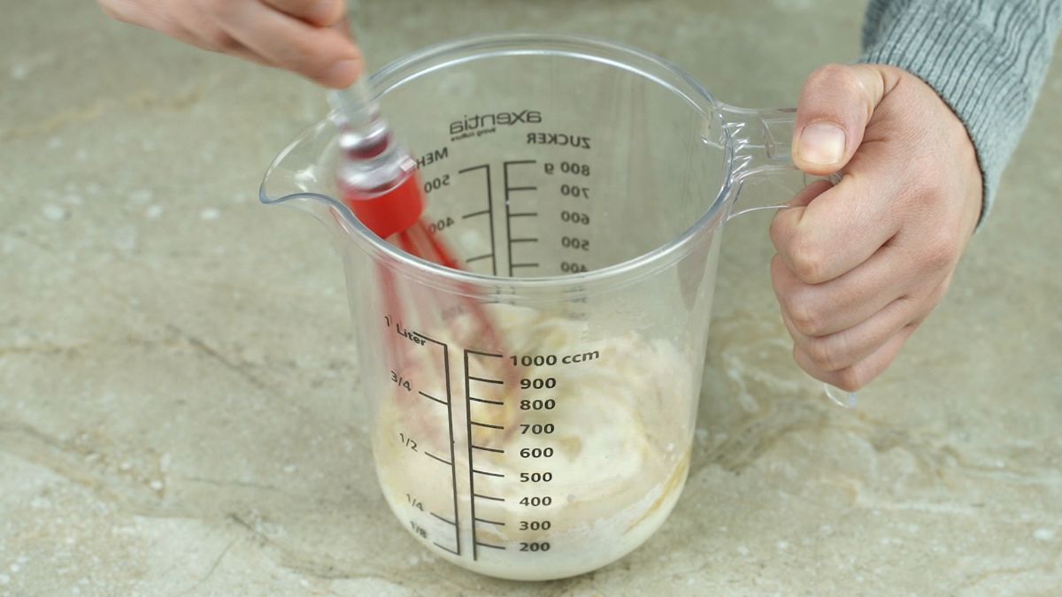 red whisk in measuring cup
