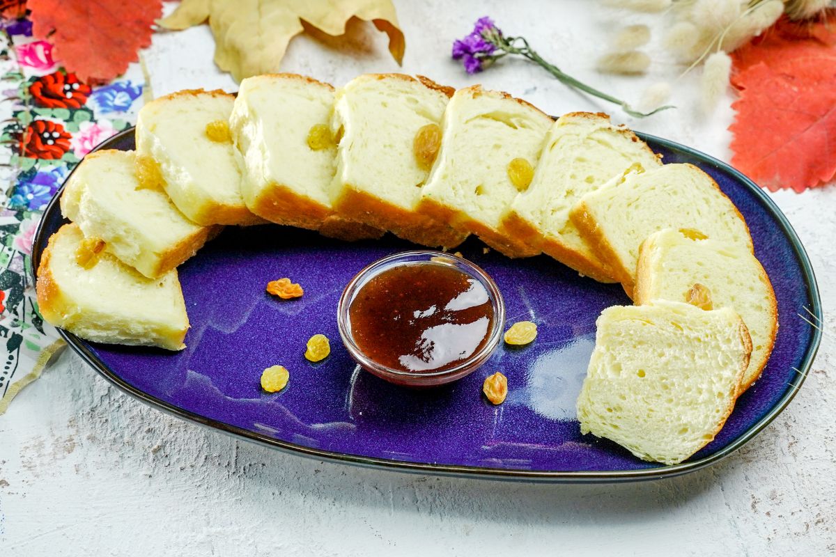 sliced bread on blue oval plate with jam dipping sauce