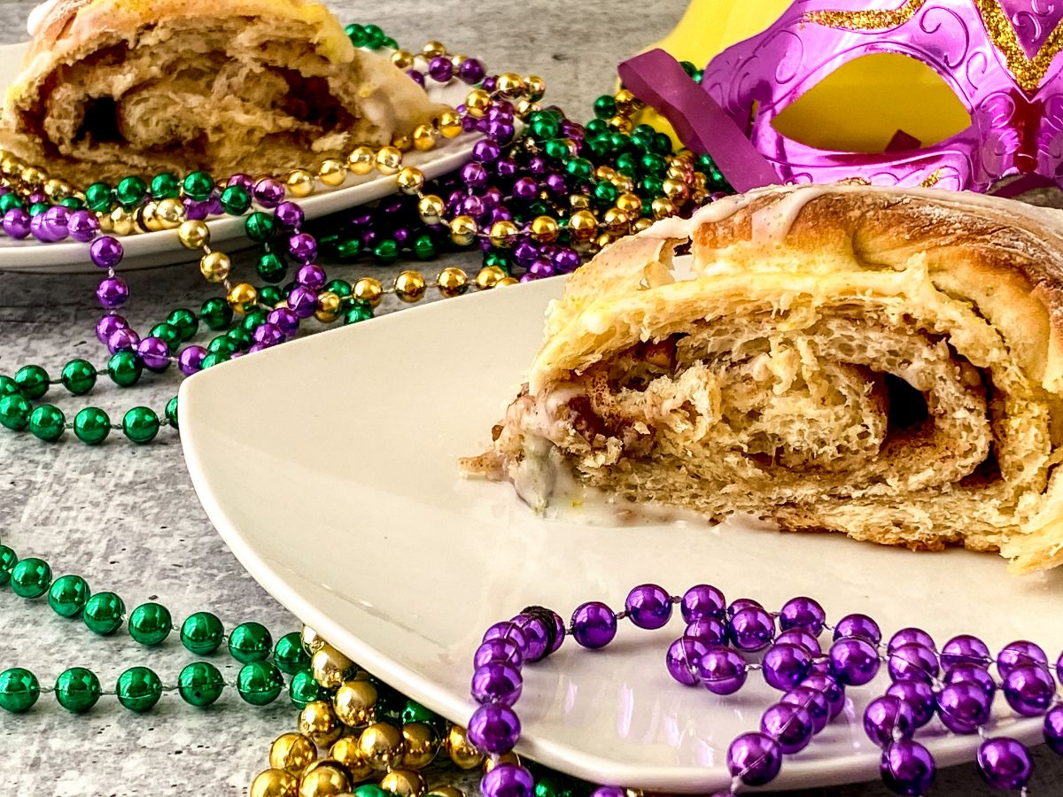 beads on table by white plate of king cake