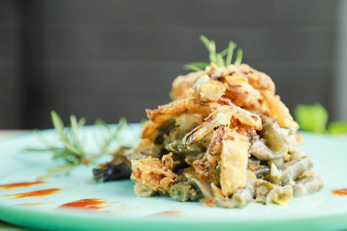 image looking straight across at green bean casserole on blue plate