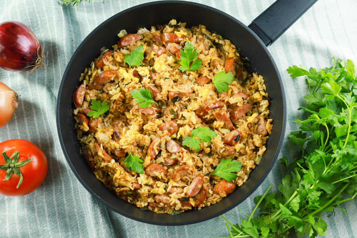skillet of fried rice sitting on striped blue tablecloth